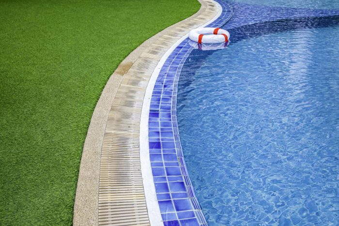artificial grass installed beside swimming pool