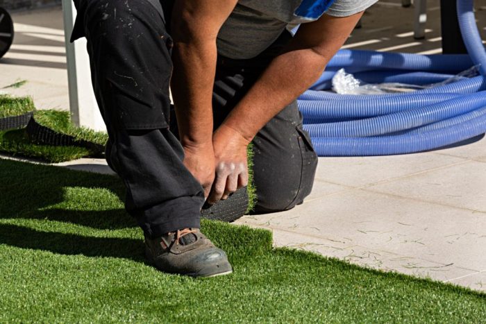 Man installing artificial grass