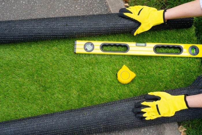 Man preparing to lay artificial grass